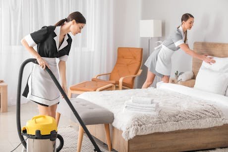 Hotel housekeeping staff preparing a room