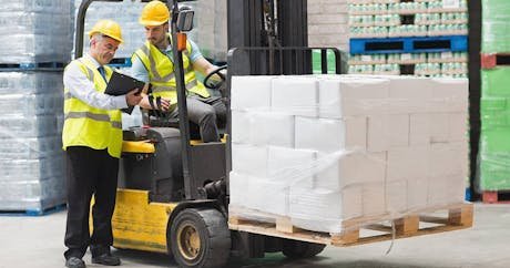 Warehouse workers coordinating a shipment