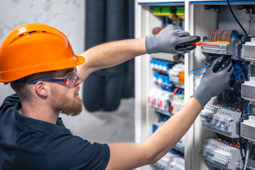 Technician working on an electrical control panel